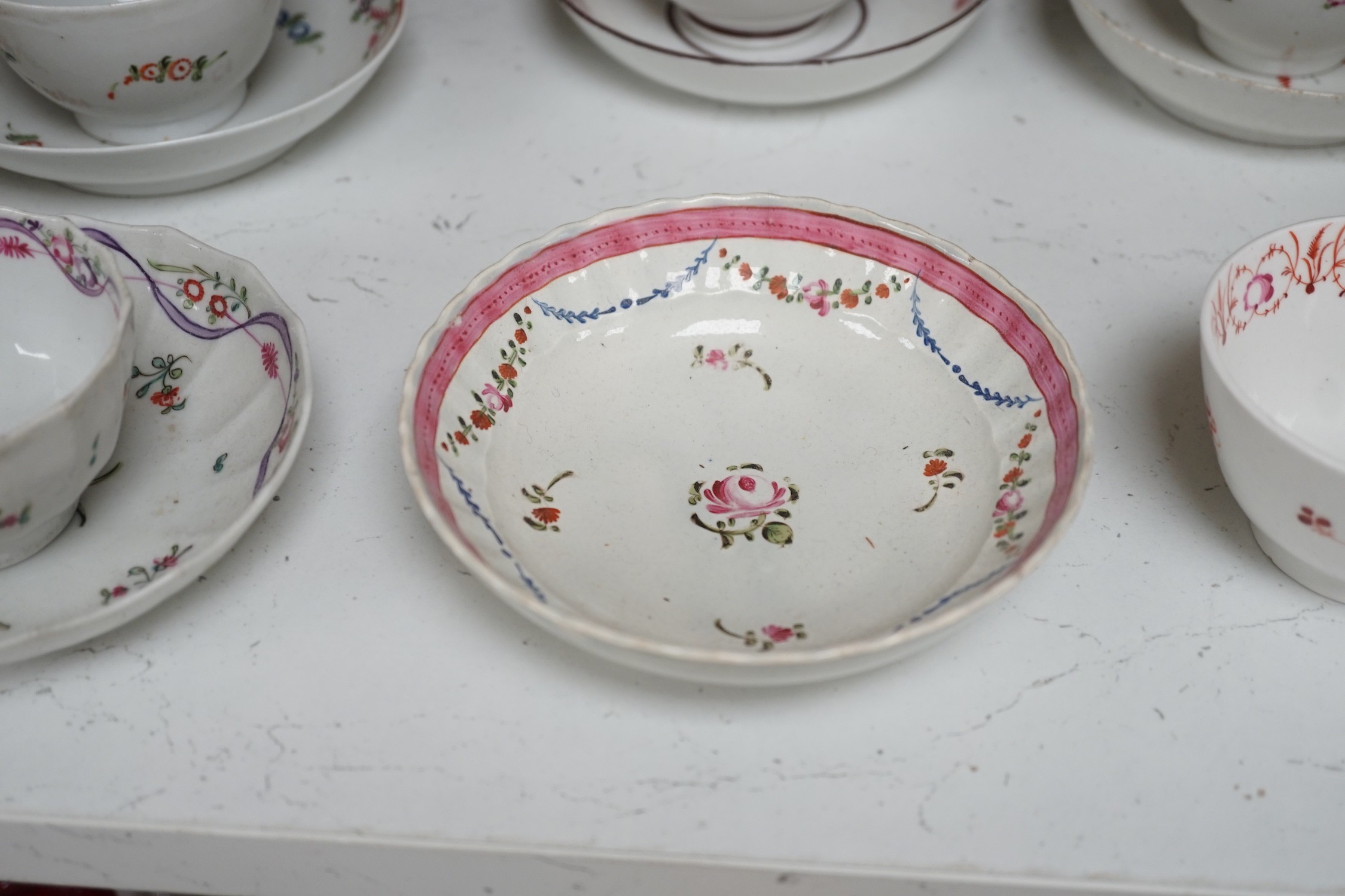 A quantity of Newhall teabowls and saucers and a pearlware tea bowl and saucer, c.1790-1800